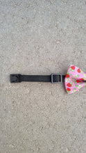 Load image into Gallery viewer, The corner of a strawberry patterned dog bow tie with a safety buckle.
