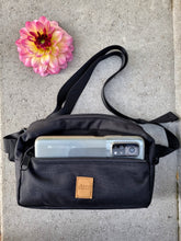 Load image into Gallery viewer, Black and square dog treat bag with a large mobile phone in the front compartment
